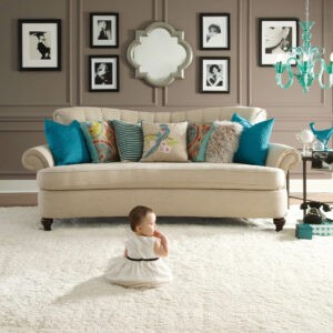 Cute baby sitting on carpet floor | CarpetsPlus Design Showroom of Hutchinson 